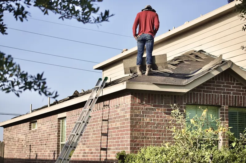 Professional roofer working on a residential roof in Leesport